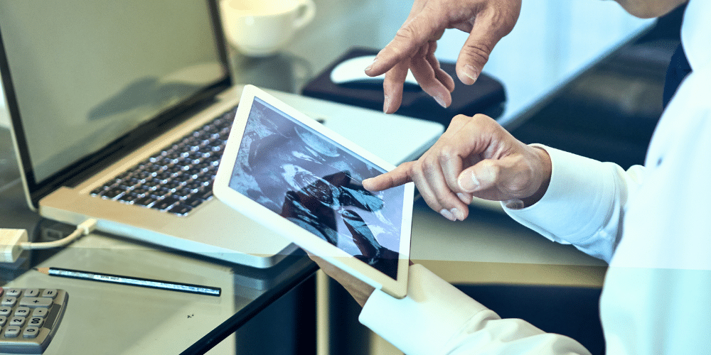 hands touching on a computer screen